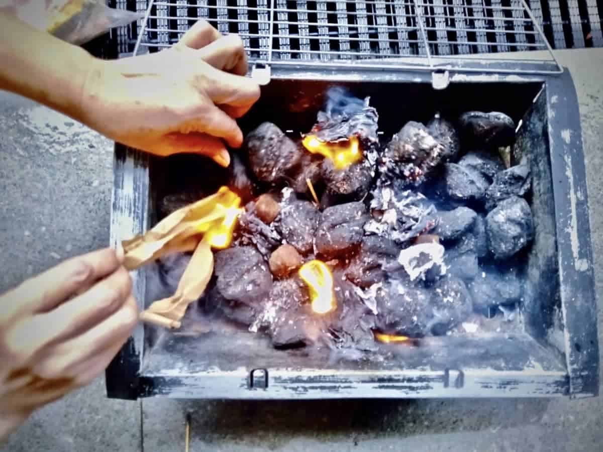 Lighting a charcoal fire.