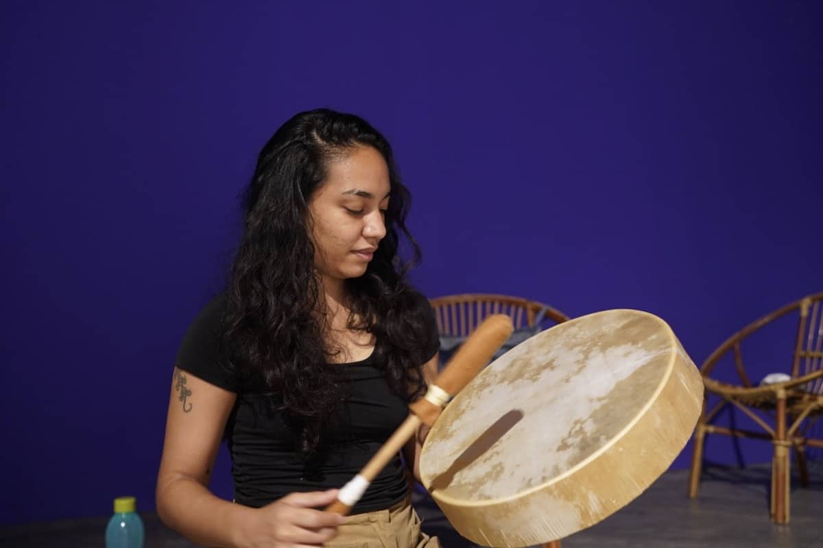 Chloe Chotrani hitting a shaman's drum