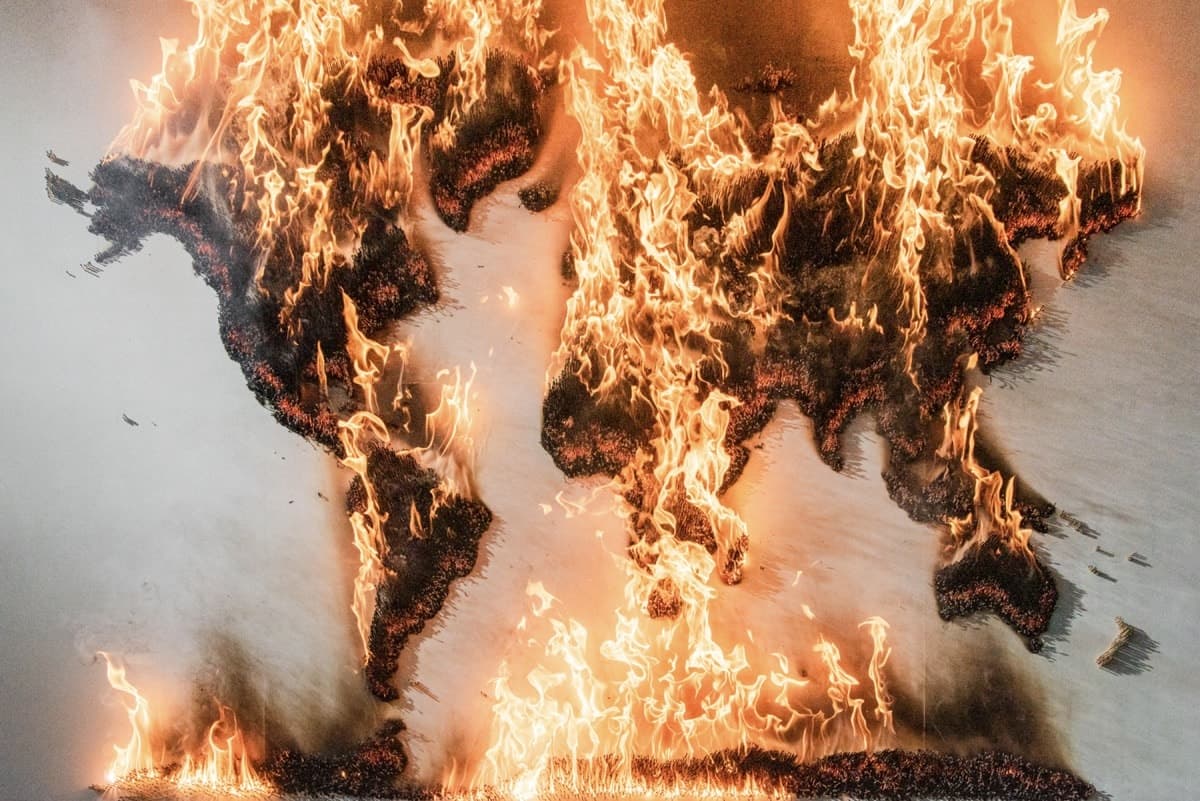 Matches burning and flames erupting from the art piece, climate is everything. Photographed by David Yeow for Time.