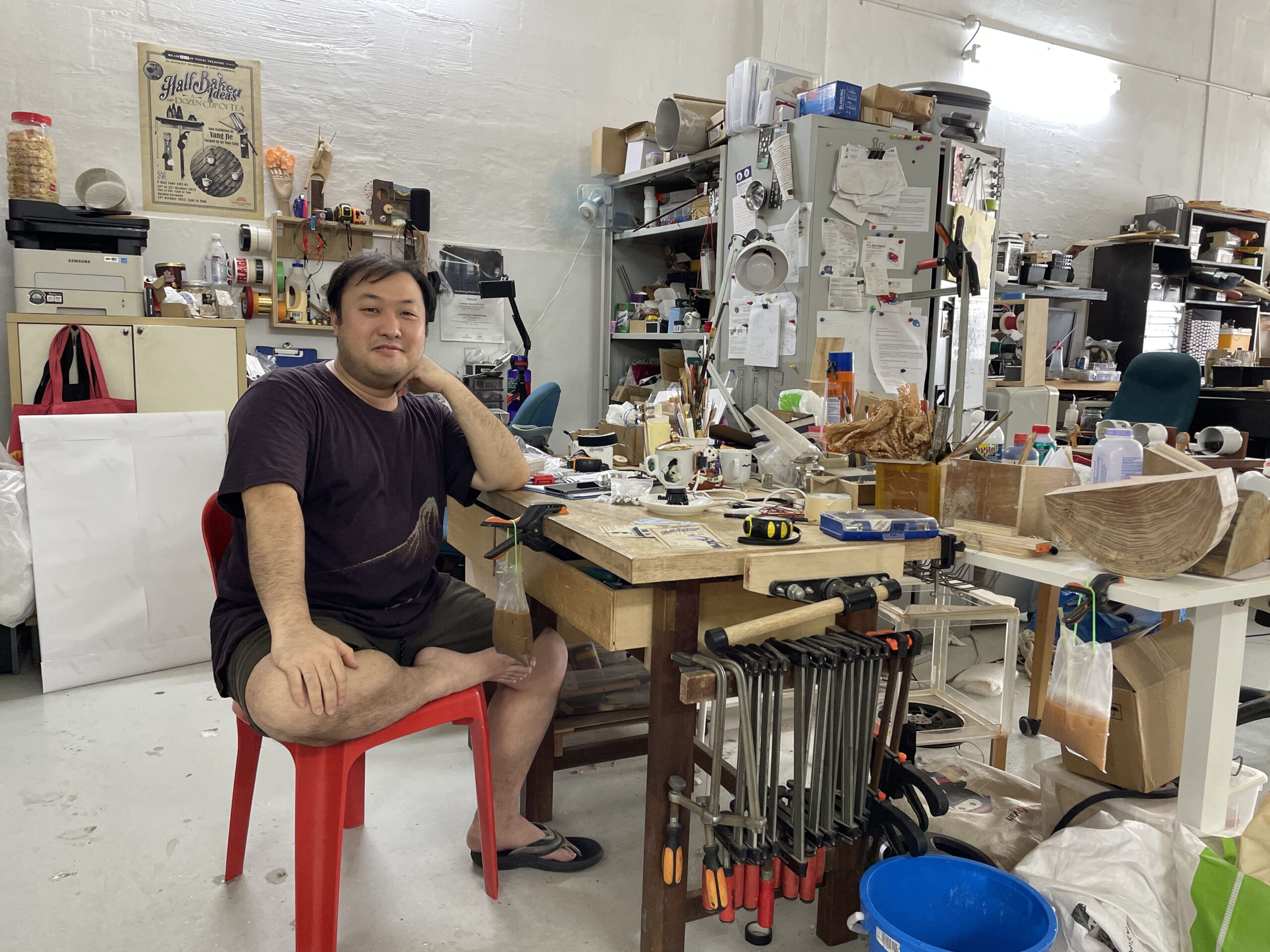 Yang Jie in his studio, seated at a table he built himself from scratch.
