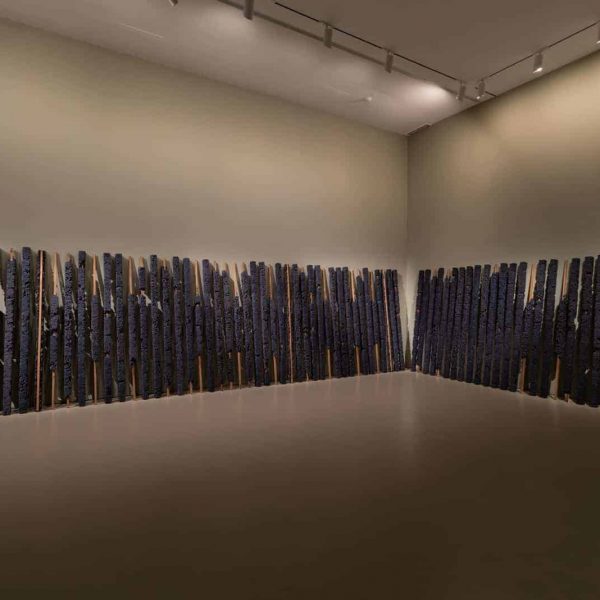 Manish Nai, Untitled, 2018, compressed indigo jute cloths and wood, total 99 pieces, 203 x 7.6 x 7.6 cm each, installation dimensions variable. Trees of Life – Knowledge in Material (2018), NTU Centre for Contemporary Art Singapore, installation view. Image courtesy of NTU CCA Singapore.