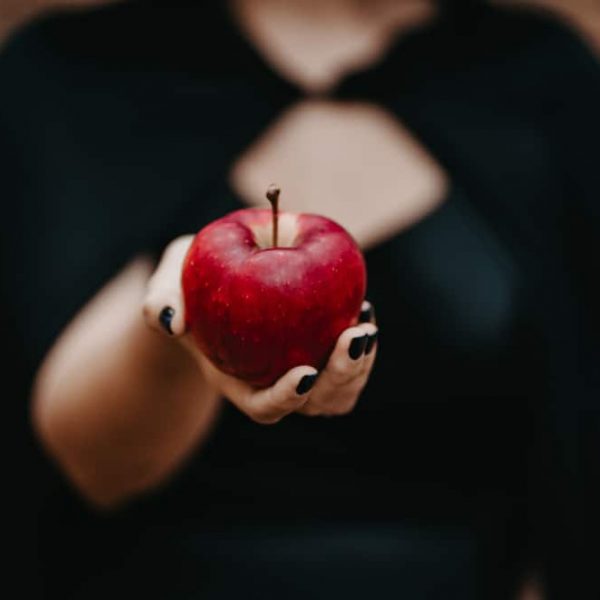Woman,As,Witch,In,Black,Offers,Red,Apple,As,Symbol